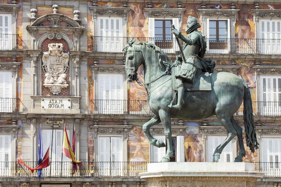 A statue of Philip the third riding a horse in the Plaza Mayor in Madrid, Spain.