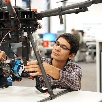 A student works with a drone in the Remote Sensing Lab at 博彩网址大全